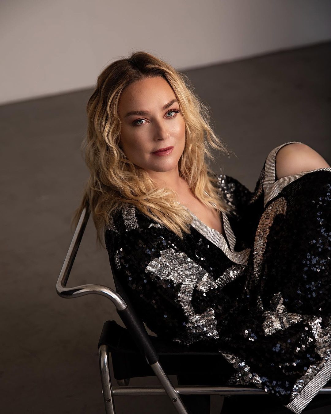 Elisabeth Röhm in a black and silver sequin set on a chrome chair for Jejune Magazine, styled by Quentin Fears
