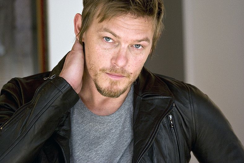 Actor Norman Reedus in a black leather jacket and grey tee, styled by Quentin Fears