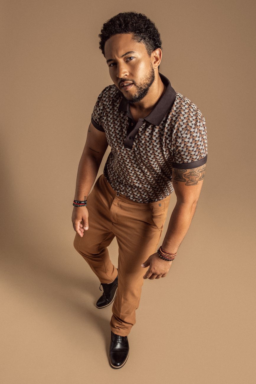 Menswear styling: a patterned knit polo with tailored camel trousers