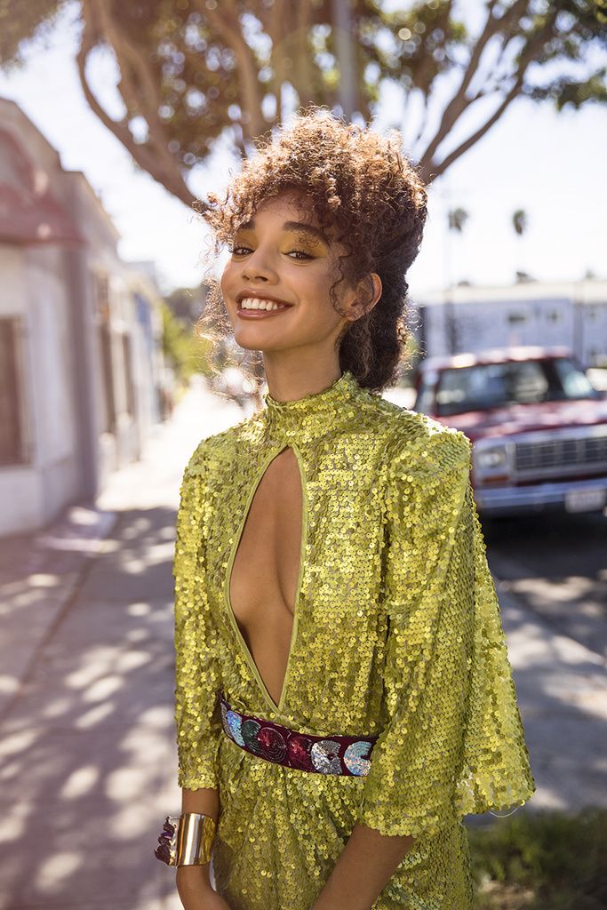 Editorial: a gold sequinned jumpsuit on a palm-lined street