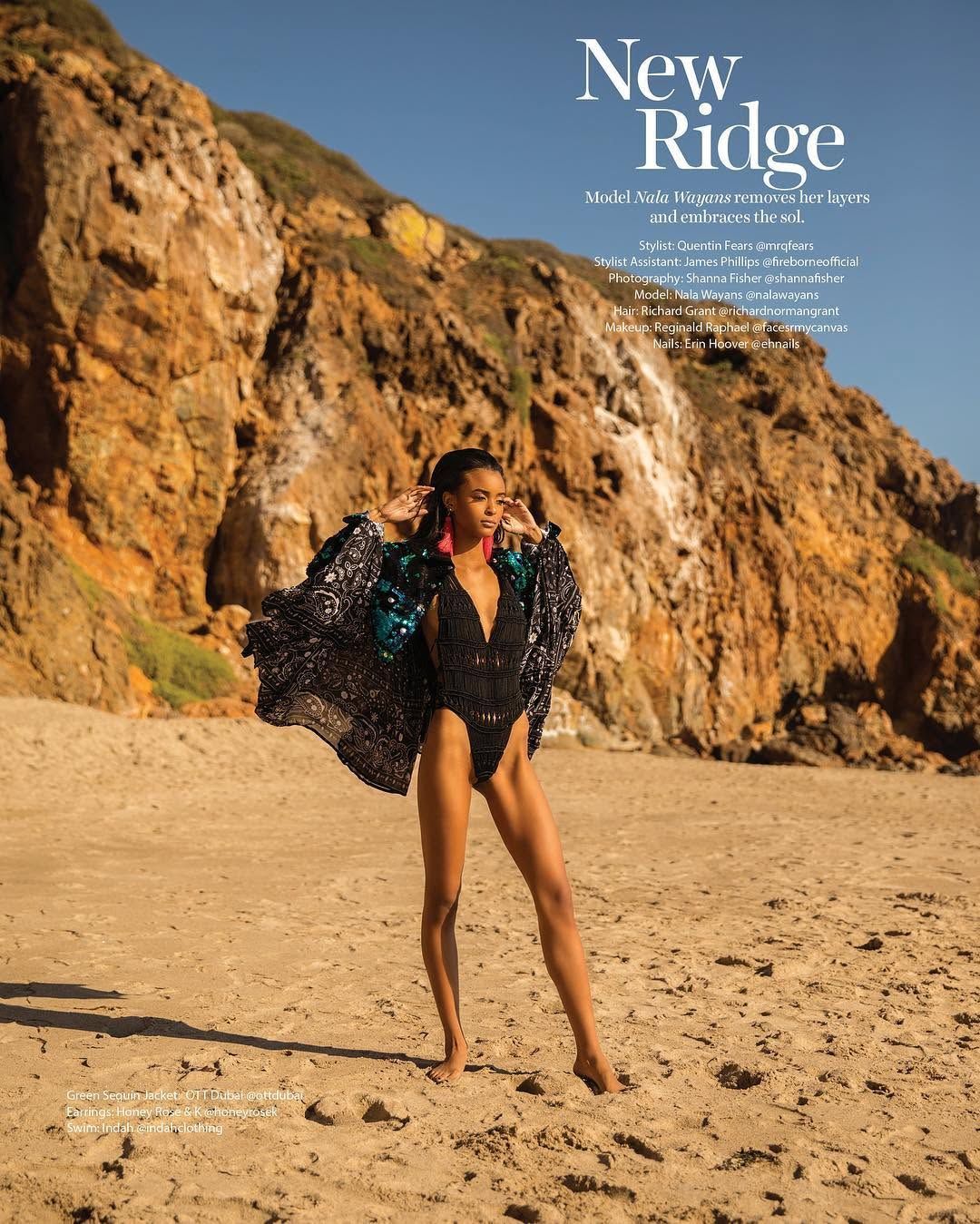 New Ridge opening page in Sheen Magazine: model Nala Wayans on a beach below orange cliffs in a sequin-trimmed bandana-print jacket over a black crochet swimsuit, styled by Quentin Fears