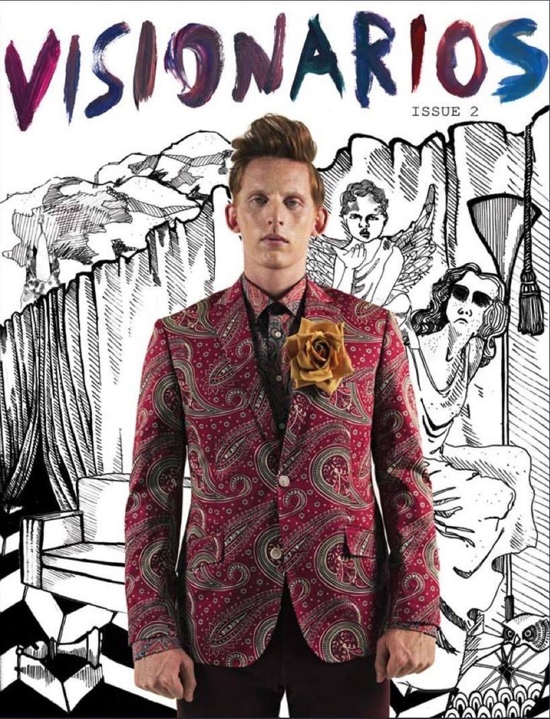 Visionarios Magazine Issue 2 cover styled by Quentin Fears: a model in a red paisley jacket and shirt with a gold rose boutonniere